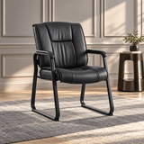 Harwick 960L black top-grain leather waiting room chair in a sunlit room beside a side table